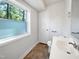 Bright bathroom featuring a vanity, window, and tiled flooring at 901 Forge Rd, Durham, NC 27713