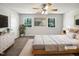 Bright bedroom featuring a ceiling fan, two windows, carpeted floors, and a double bed at 901 Forge Rd, Durham, NC 27713