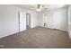 Large bedroom featuring carpeted floors, a ceiling fan, and multiple closets at 901 Forge Rd, Durham, NC 27713