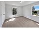 Bedroom featuring carpeted floors, a large window, and a closet at 901 Forge Rd, Durham, NC 27713