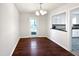 Dining room featuring hardwood floors, a modern chandelier, and access to the kitchen at 901 Forge Rd, Durham, NC 27713