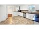 Kitchen with white cabinets, stainless steel appliances, and a breakfast bar at 901 Forge Rd, Durham, NC 27713