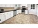Kitchen with white cabinets, stainless steel appliances, and a black countertop at 901 Forge Rd, Durham, NC 27713