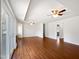 Spacious living room with hardwood floors, two ceiling fans, and access to the backyard at 901 Forge Rd, Durham, NC 27713