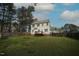 Spacious backyard featuring a wooden deck, fire pit, and a privacy fence, perfect for outdoor enjoyment at 910 Cedar Creek Dr, Wendell, NC 27591