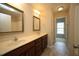 Bathroom featuring double sinks, tile floor, and updated lighting at 910 Cedar Creek Dr, Wendell, NC 27591