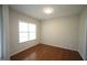 Bright bedroom with a large window offering plenty of natural light and hardwood floors at 910 Cedar Creek Dr, Wendell, NC 27591