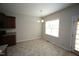 Bright dining area with a modern chandelier and tiled flooring with access to the back door at 910 Cedar Creek Dr, Wendell, NC 27591