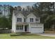 Charming two-story home featuring light siding, dark shutters, an attached two-car garage, and a well-maintained lawn at 910 Cedar Creek Dr, Wendell, NC 27591