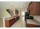 Well-lit kitchen featuring a tiled floor, laminate countertops, and wood cabinetry at 910 Cedar Creek Dr, Wendell, NC 27591