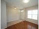 Entryway leading to the living room, featuring hardwood floors, carpet and a white front door at 910 Cedar Creek Dr, Wendell, NC 27591