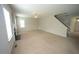 Spacious living room with neutral carpet, a ceiling fan, a fireplace, and abundant natural light at 910 Cedar Creek Dr, Wendell, NC 27591