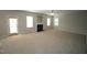 Large living room featuring a fireplace, a ceiling fan, and an outdoor access door at 910 Cedar Creek Dr, Wendell, NC 27591