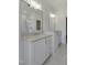 Bright bathroom features double sinks, quartz countertops, sleek hardware, and oversized mirror at 964 Double Helix Rd, Apex, NC 27523