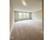 Expansive bonus room with plush carpet and trim boasts windows for natural light and comfortable space at 964 Double Helix Rd, Apex, NC 27523