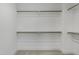 Spacious walk-in closet features carpeted floor and built-in shelving offering plenty of space at 964 Double Helix Rd, Apex, NC 27523