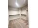 Walk-in closet with carpeted floor and built-in shelving provides ample storage space at 964 Double Helix Rd, Apex, NC 27523