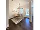 Modern dining room features stylish light fixture, four chairs, and a door to the outdoor area at 964 Double Helix Rd, Apex, NC 27523