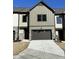 Townhome featuring neutral siding, stone accents, and an attached garage with a concrete driveway at 964 Double Helix Rd, Apex, NC 27523