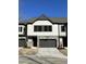 Townhome exterior with neutral siding, stone accents, attached garage, and well-kept front lawn at 964 Double Helix Rd, Apex, NC 27523