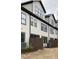 Townhome exterior featuring neutral siding, dark trim, fenced-in patios, and well-maintained landscaping at 964 Double Helix Rd, Apex, NC 27523
