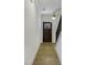 Hallway features an entryway with dark wood front door, leading to the staircase with modern railing at 964 Double Helix Rd, Apex, NC 27523