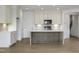 Bright kitchen with white cabinets, tile backsplash, stainless steel appliances, and hardwood flooring at 964 Double Helix Rd, Apex, NC 27523
