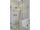 Modern frameless shower with dual showerheads, sleek tile work and adjacent tub at 964 Double Helix Rd, Apex, NC 27523