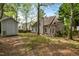 Spacious backyard featuring a storage shed, a brick patio, manicured lawn, and lush, mature trees at 1012 Trail Stream Way, Knightdale, NC 27545