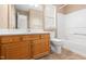 Bathroom featuring tile floors, wooden vanity, a toilet, shower and bathtub combination and mirror at 1012 Trail Stream Way, Knightdale, NC 27545