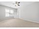 Neutral bedroom featuring carpeted floors, a ceiling fan, a window, and built-in shelving storage at 1012 Trail Stream Way, Knightdale, NC 27545