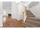 Spacious foyer with hardwood floors, staircase, and access to the living room at 1012 Trail Stream Way, Knightdale, NC 27545