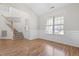 Open living space with hardwood floors and a large window for lots of natural light at 1012 Trail Stream Way, Knightdale, NC 27545