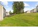 Expansive backyard featuring mature trees, a well-maintained lawn, and a wooden fence for added privacy at 104 Rosebud Ln, Durham, NC 27704