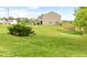 Spacious backyard featuring a well-maintained lawn, a bench, and a beautiful green bush at 104 Rosebud Ln, Durham, NC 27704