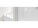 Bright white bathtub and shower combo with clean lines and modern fixtures at 104 Rosebud Ln, Durham, NC 27704