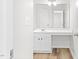 Bright bathroom featuring a single sink vanity with a large mirror and modern fixtures at 104 Rosebud Ln, Durham, NC 27704