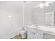 Bright bathroom with white fixtures, including a tub, toilet, and vanity with a large mirror at 104 Rosebud Ln, Durham, NC 27704