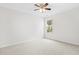 Large bedroom featuring neutral carpet, a ceiling fan, and a window at 104 Rosebud Ln, Durham, NC 27704
