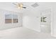 A carpeted bedroom with white walls, a ceiling fan, and a view of another room at 104 Rosebud Ln, Durham, NC 27704