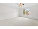Bright bedroom featuring a ceiling fan, large window, and neutral carpet at 104 Rosebud Ln, Durham, NC 27704