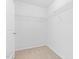 Walk-in closet featuring neutral carpet, a wire shelf and a white door at 104 Rosebud Ln, Durham, NC 27704