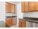 A kitchen featuring wood cabinets, stainless steel appliances, and dark countertops at 104 Rosebud Ln, Durham, NC 27704