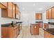 A kitchen showcasing wood cabinets, stainless steel appliances, dark countertops, and a center island at 104 Rosebud Ln, Durham, NC 27704