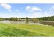 Scenic lake view with lush greenery and a well-maintained lawn in the foreground at 104 Rosebud Ln, Durham, NC 27704
