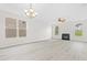 Expansive living room with fireplace, updated flooring, and modern lighting at 104 Rosebud Ln, Durham, NC 27704