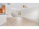 Bright living room with wood-look floors, ceiling fan, and a view of the staircase at 104 Rosebud Ln, Durham, NC 27704