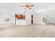 Open concept living area with wood-look floors, a kitchen bar, and modern light fixtures at 104 Rosebud Ln, Durham, NC 27704