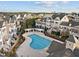 Aerial view of community pool with lounge area surrounded by homes and lush landscaping at 10410 Sablewood Dr # 111, Raleigh, NC 27617