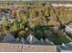 Scenic aerial view of a neighborhood with lush trees and well-maintained homes, close to a lake at 10410 Sablewood Dr # 111, Raleigh, NC 27617